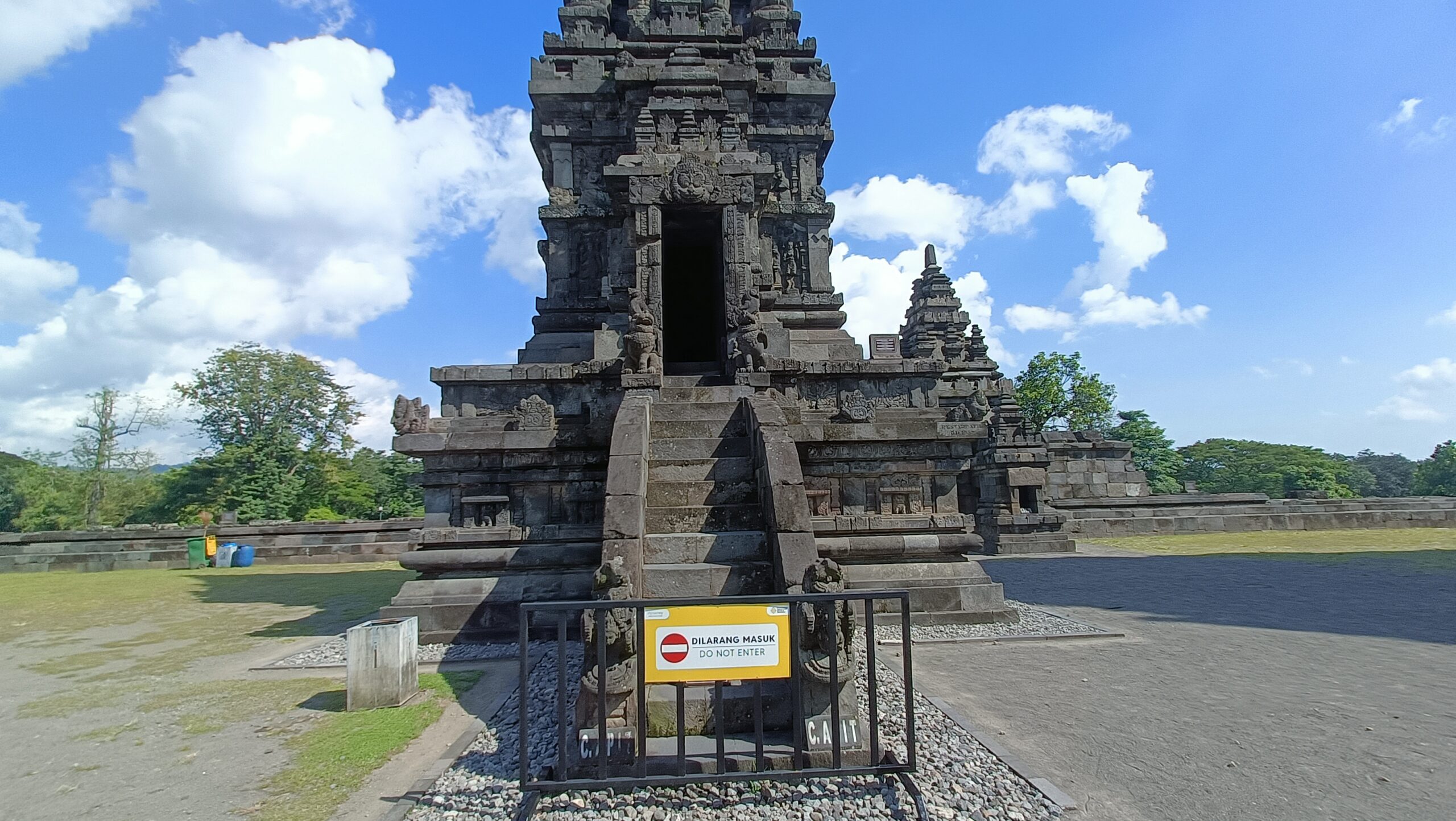 Prambanan Temple: The 00:00 Guide to Java’s Hindu Twin Small ruined temple Candi Angsa at Prambanan with stone staircase and no entry sign blue sky Yogyakarta Indonesia