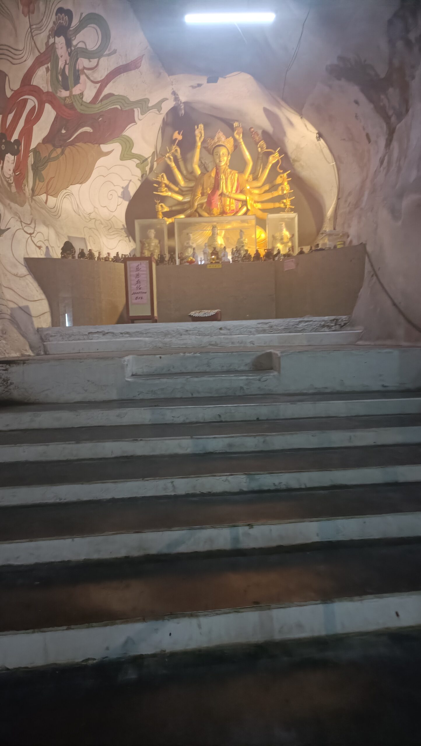 Golden thousand-handed Guan Yin statue on an altar inside Perak Tong Cave Temple in Ipoh