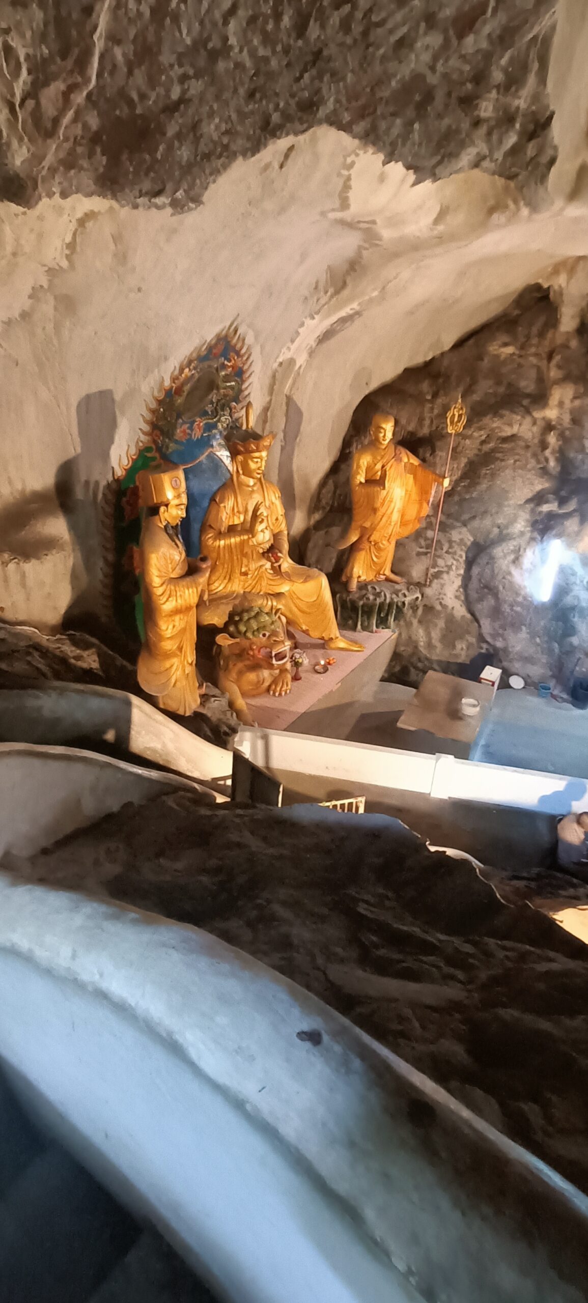 Main Buddha altar inside Perak Tong Cave Temple with stone cave ceiling