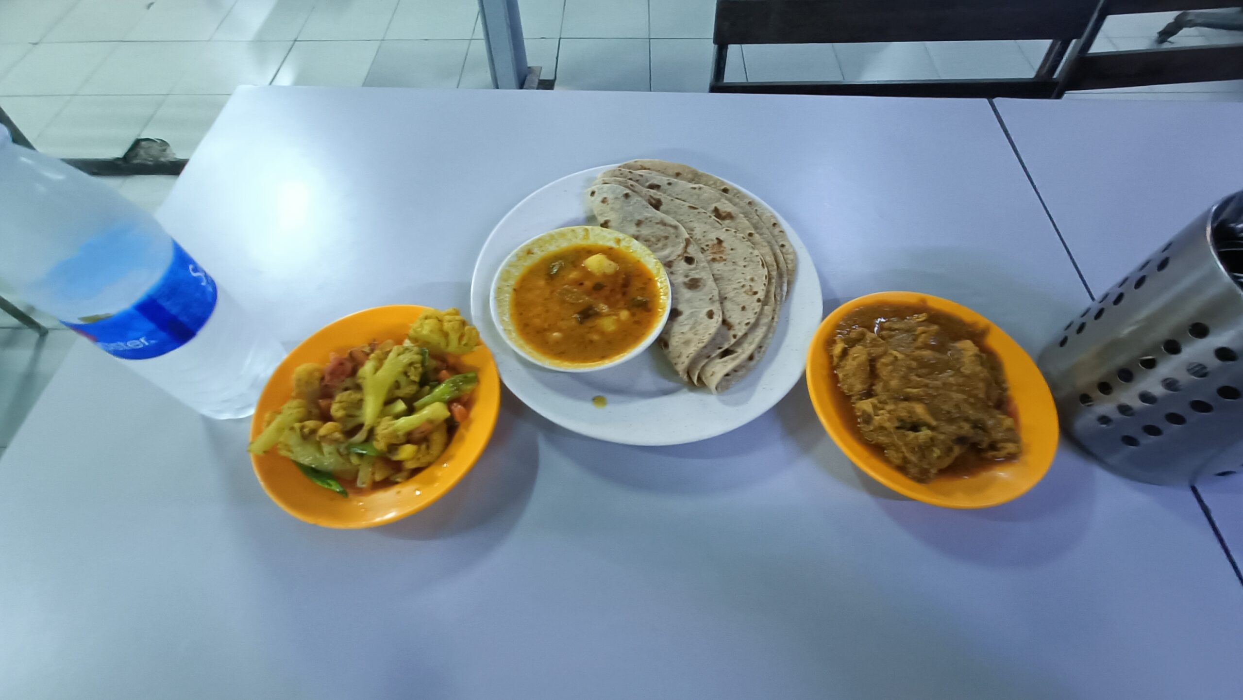 I Broke My Veg Day for 4 Chapati at Tiger Jit. 1:0, Day 2.0 4 Chapati with dhal on center, curry chicken on the right side. With veg to balance and water to cool down.